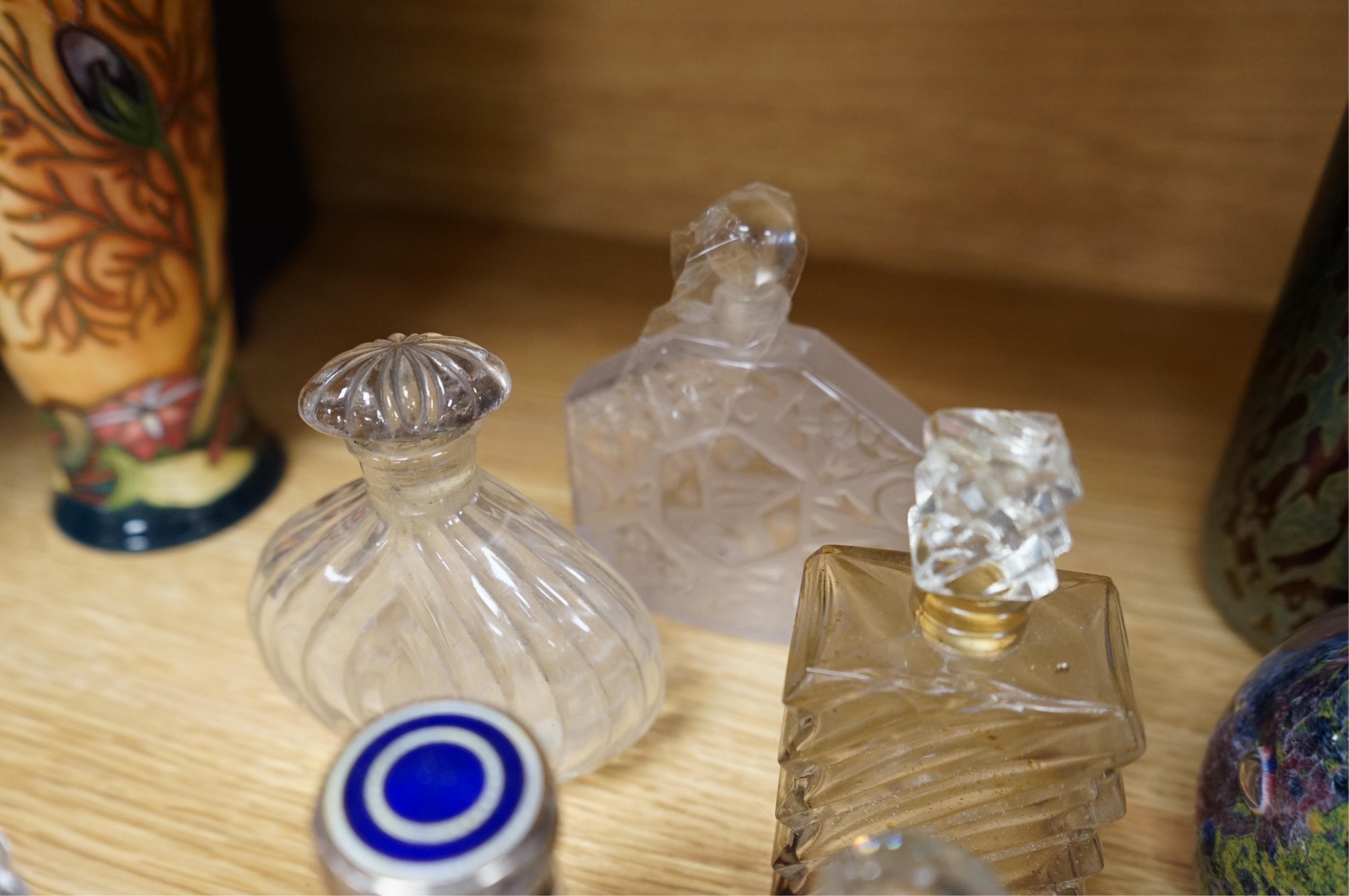 A collection of scent bottles, cranberry glass salts, three glass paperweights and a vase. tallest 18cm high